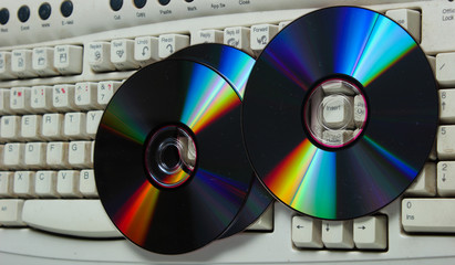CDs on a retro computer keyboard