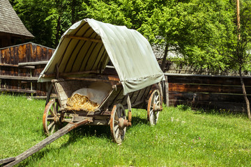 old covered wagon in the courtyard of a Romanian village