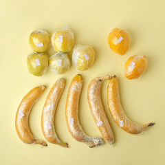 Fruits in plastic packaging, pollution of earth concept, supermarket packaging, Concept of ecology problem, no plastic, zero waste agaist of no reuse wrapped