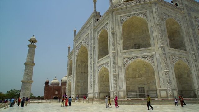 A hand held, low angle, medium shot of the beautifully painted and sculpted fa ade of the mosque.