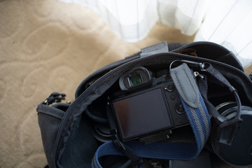 digital camera in bag on carpet