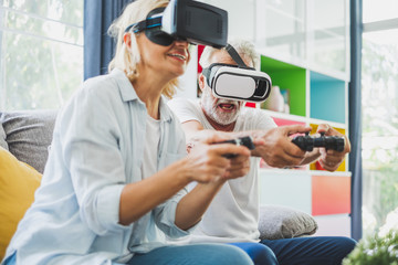 Couple senior enjoy playing VR 3D games at home