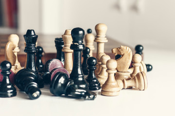 Old well used wooden chess pieces, retro leadership concept on white background.