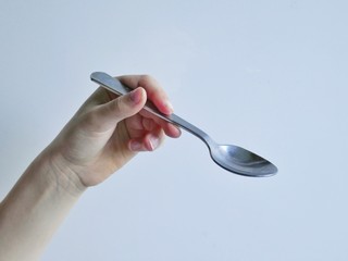 hand with spoon