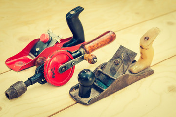 Joinery – old wooden plane, wood polishing tool in a workshop of the carpenter, retro concept.