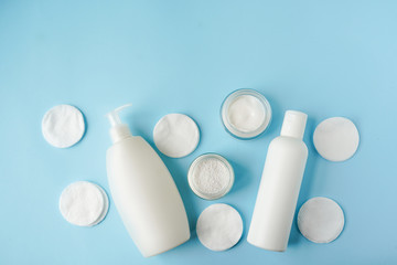 Bath products and cotton pads on blue background copy space. spa, bathing concept