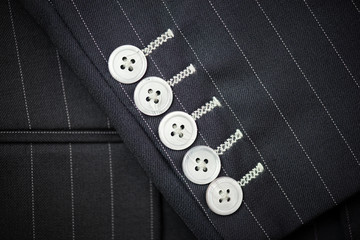 Bespoke jacket selective focused on sleeve buttons,top view..Close up detail of five sleeve ...