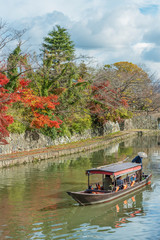 tourist on boat sightseeing around Hachiman-bori canal in Omihachiman, Japan
