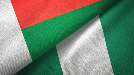 Obraz premium Madagascar and Nigeria two flags textile cloth, fabric texture