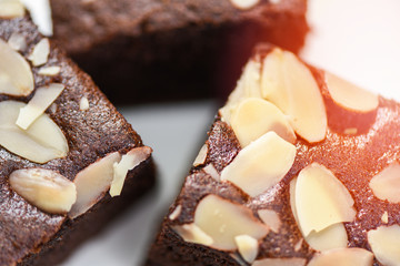 Close up brownies cake slice with nut on plate background