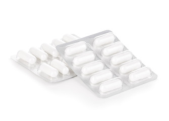 Capsule pills in blister pack close-up isolated on a white background.