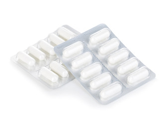 Capsule pills in blister pack close-up isolated on a white background.