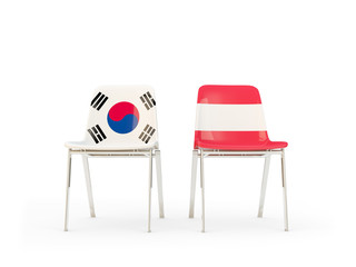 Two chairs with flags of South Korea and austria isolated on white