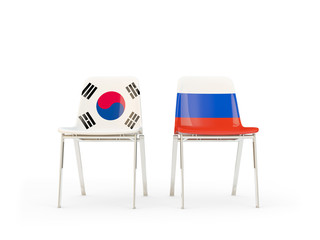 Two chairs with flags of South Korea and russia isolated on white