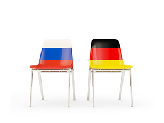 Two chairs with flags of Russia and germany isolated on white