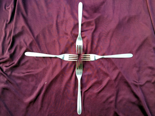 Simple set of fork, isolated on VIOLET background.