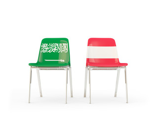 Two chairs with flags of Saudi Arabia and austria isolated on white