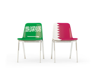 Two chairs with flags of Saudi Arabia and qatar isolated on white