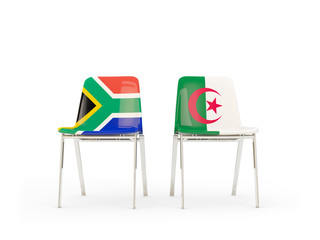 Two chairs with flags of South Africa and algeria isolated on white