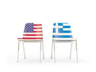 Two chairs with flags of United States and greece isolated on white