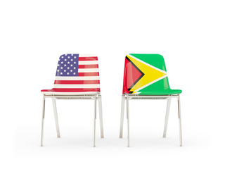 Two chairs with flags of United States and guyana isolated on white