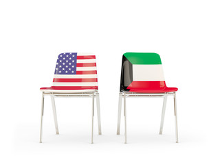 Two chairs with flags of United States and kuwait isolated on white