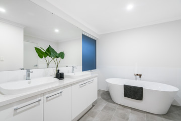 Large modern bathroom interior with high end fittings and stand alone bathtub. PERTH, AUSTRALIA....