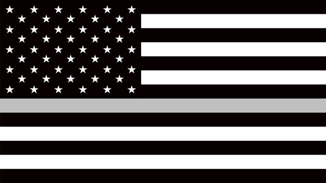 USA flag with a thin gray or silver - a sign to honor and respect american correctional officers, prison guards and jailers.