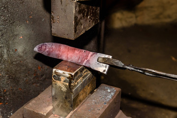 Forging molten metal. Making knives.