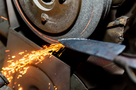 Blacksmith, knife sharpening, sparks, metal.