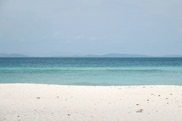 Fototapeta na wymiar White sand with the blue sea for summer concept