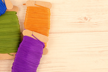 colorful stacking cotton yarn wool on wooden background. copy space for text