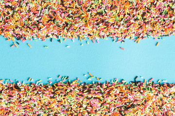 abstract picture of colorful topping sugar.topping sugar sprinkles on blue background.