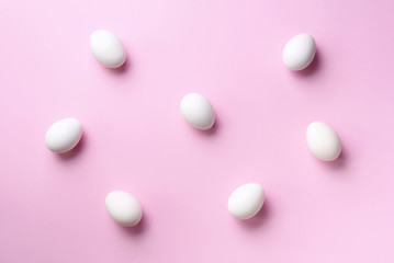 Food concept with white chicken eggs on pink background. Top view. Creative pattern in minimal style. Flat lay.