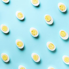 Food concept with boiled eggs pattern on blue background. Top view. Creative pattern in minimal style. Flat lay. Square crop
