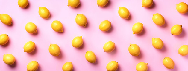 Food pattern with lemons on pink paper background. Top view. Summer concept. Vegan and vegetarian diet. Banner