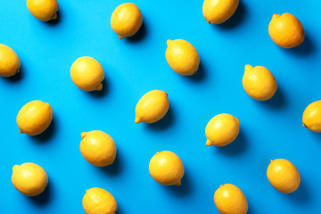 Food pattern with lemons on blue paper background. Top view. Summer concept. Vegan and vegetarian diet