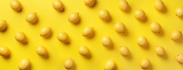 Food pattern with lemons on yellow paper background. Top view. Summer concept. Vegan and vegetarian diet. Banner