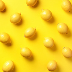 Food pattern with lemons on yellow paper background. Top view. Summer concept. Vegan and vegetarian diet. Square crop
