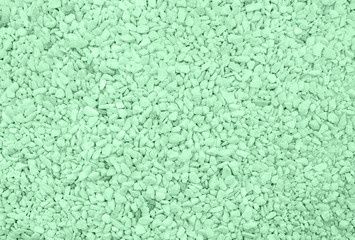 Top shot of trendy mint colored Pebble beach texture. Neutral monochrome nature background
