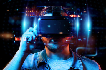 Portrait of a man with glasses of virtual reality, vr, interacts with a virtual screen. The concept of the future is here, applications complement reality, the interface of virtual reality