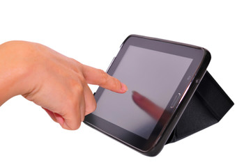 Black tablet with a blank screen in the hands on table