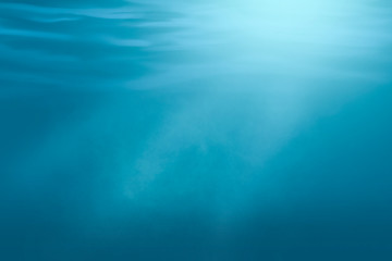 Underwater scene illustration with light rays. Blue shiny background.