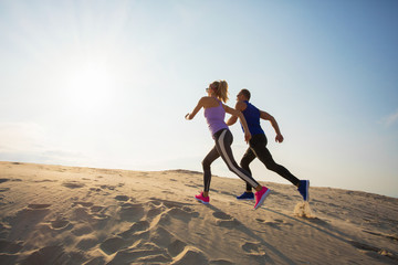 Energetic couple running uphill