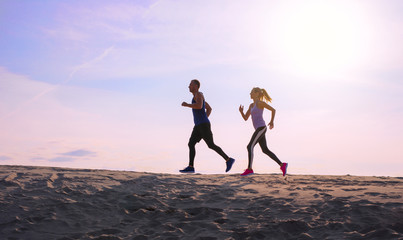 Two people jogging at sunset