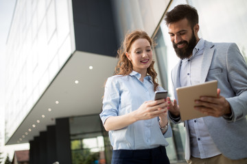Picture of young attractive business partners standing