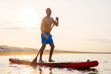 Man enjoying ride on paddle board