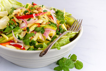 Thai Raw Mango Salad with Roasted Peanuts Served in a White Bowl. Summer Food, Healthy Eating, Seasonal Fruit, .Vegan Food Photography.