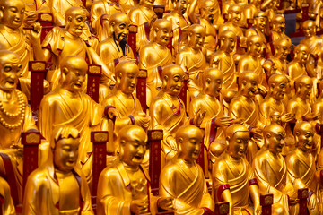 A lot of gold statues of the Lohans in Longhua Temple in Shanghai, China. Famous buddhist temple in China.