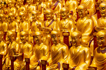 A lot of gold statues of the Lohans in Longhua Temple in Shanghai, China. Famous buddhist temple in China.